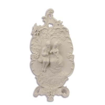 A BISQUE PLAQUE ON STAND OF A ROMANTIC SCENE