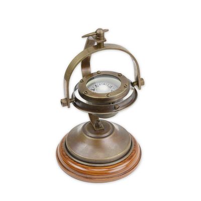 A BRASS COMPASS ON STAND