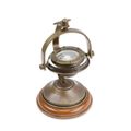 A BRASS COMPASS ON STAND