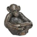A BRONZE CHIMPANSEE HOLDING A BOWL