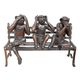 A BRONZE SCULPTURE OF 3 MONKEYS ON A BENCH