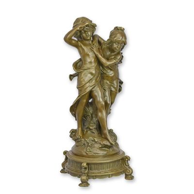 A BRONZE SCULPTURE OF A BOY AND GIRL