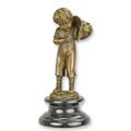A BRONZE SCULPTURE OF A BOY LIGHTING A CIGARET