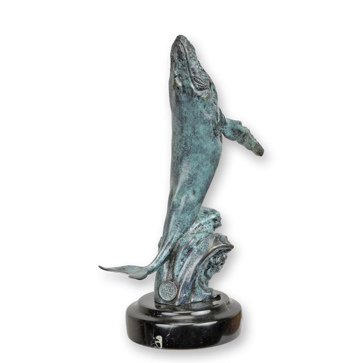 A BRONZE SCULPTURE OF A BREACHING HUMPBACK WHALE
