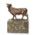 A BRONZE SCULPTURE OF A BULL
