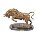 A BRONZE SCULPTURE OF A CHARGING BULL