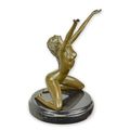 A BRONZE SCULPTURE OF A FEMALE NUDE