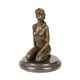 A BRONZE SCULPTURE OF A FEMALE NUDE