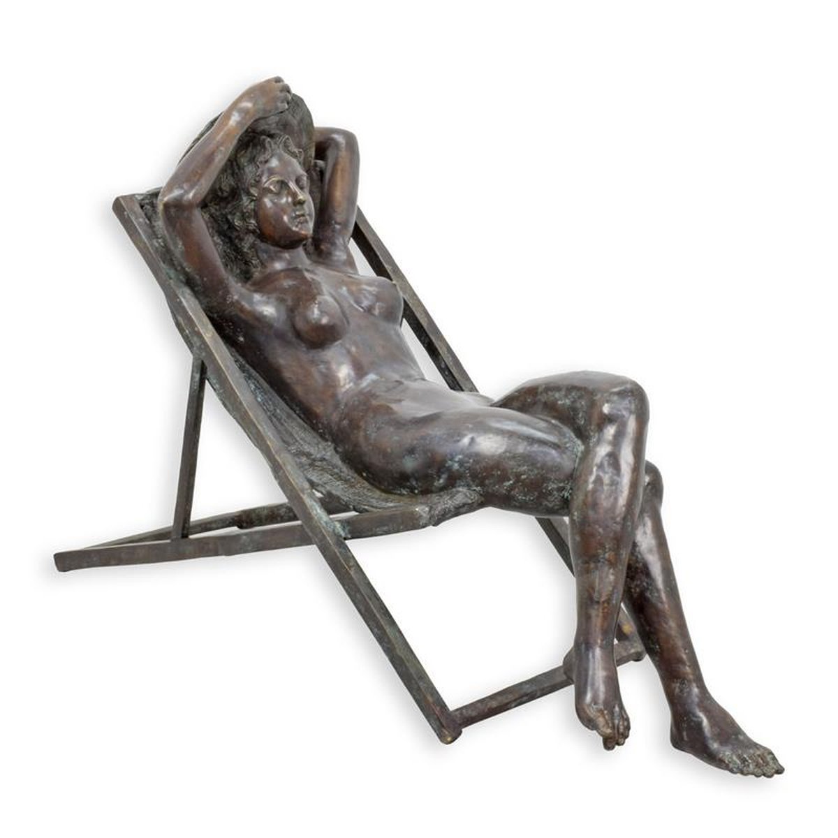 A BRONZE SCULPTURE OF A FEMALE NUDE IN BEACH CHAIR