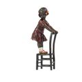 A BRONZE SCULPTURE OF A GIRL ON STOOL