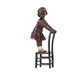 A BRONZE SCULPTURE OF A GIRL ON STOOL