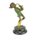 A BRONZE SCULPTURE OF A GOBLIN PLAYING SAXOPHONE
