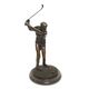 A BRONZE SCULPTURE OF A GOLFER