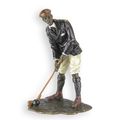 A BRONZE SCULPTURE OF A GOLFER