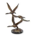 A BRONZE SCULPTURE OF A GROUP OF FLYING GEESE