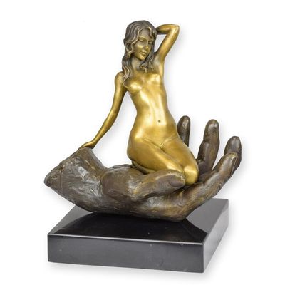 A BRONZE SCULPTURE OF A HAND HOLDING A WOMAN