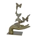 A BRONZE SCULPTURE OF A HAND UNLEASHING BUTTERFLIES