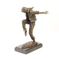 A BRONZE SCULPTURE OF A HOODED STREETDANCER