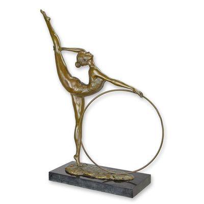 A BRONZE SCULPTURE OF A HOOP DANCER