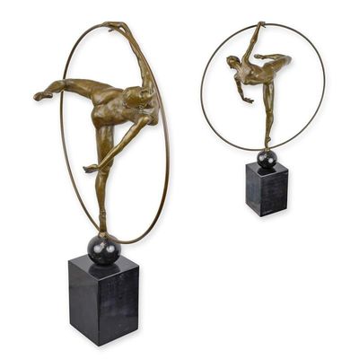 A BRONZE SCULPTURE OF A HOOP DANCER