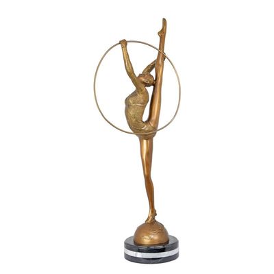 A BRONZE SCULPTURE OF A HOOP DANCER