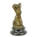 A BRONZE SCULPTURE OF A KNEELING NUDE