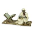 A BRONZE SCULPTURE OF A KORAN SCRIBE