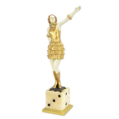 A BRONZE SCULPTURE OF A LADY MOUNTED ON A DICE SHAPED BASE