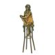 A BRONZE SCULPTURE OF A LADY ON BARCHAIR