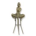 A BRONZE SCULPTURE OF A LADY ON BARCHAIR