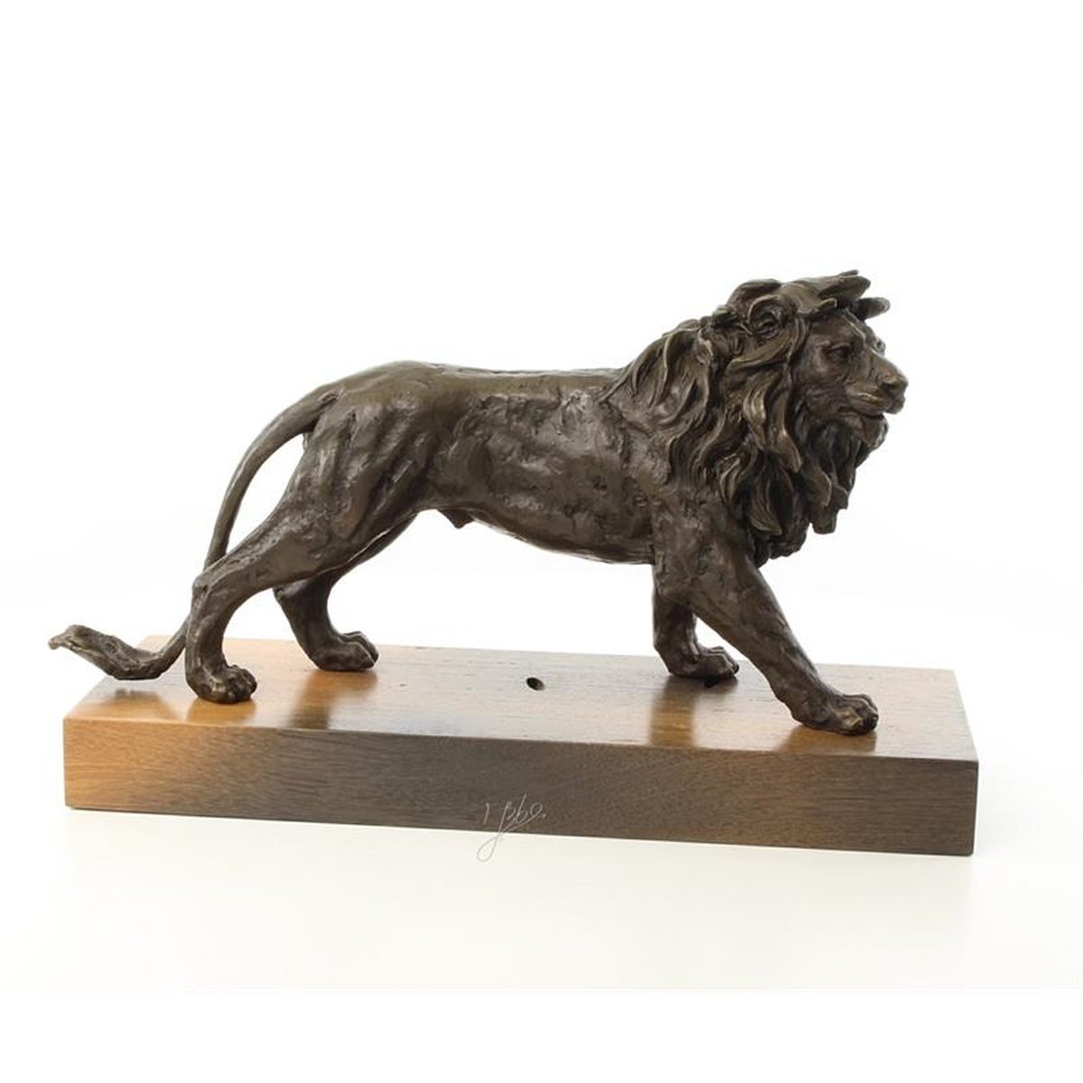 A BRONZE SCULPTURE OF A LION MOUNTED ON A WOODEN PLANK