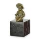 A BRONZE SCULPTURE OF A LITTLE BOY SITTING