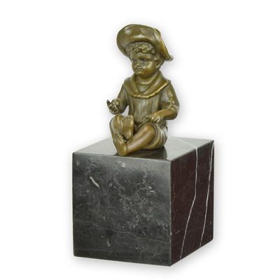 A BRONZE SCULPTURE OF A LITTLE BOY SITTING