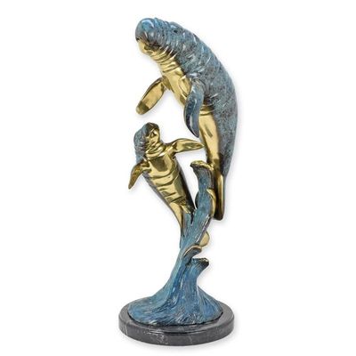 A BRONZE SCULPTURE OF A MANATEE WITH YOUNG