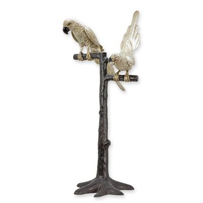 A BRONZE SCULPTURE OF A PAIR OF PARROTS ON A BRANCH