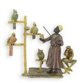 A BRONZE SCULPTURE OF A PARROT TRAINER