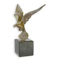 A BRONZE SCULPTURE OF A PIGEON IN FLIGHT