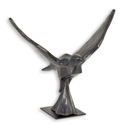 A BRONZE SCULPTURE OF A PIGEON IN FLIGHT