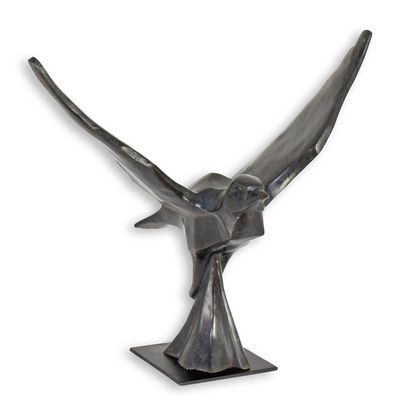 A BRONZE SCULPTURE OF A PIGEON IN FLIGHT