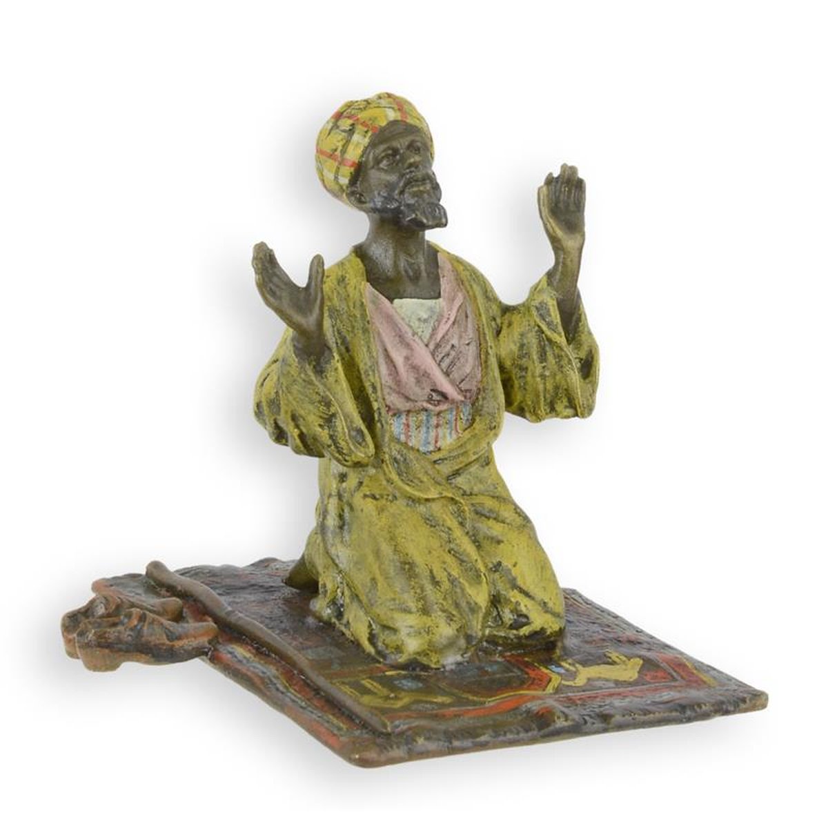 A BRONZE SCULPTURE OF A PRAYER ON RUG