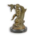 A BRONZE SCULPTURE OF A PUTTO ON A FISH