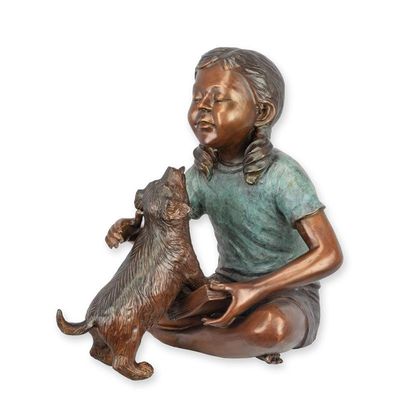 A BRONZE SCULPTURE OF A READING GIRL WITH PUPPY