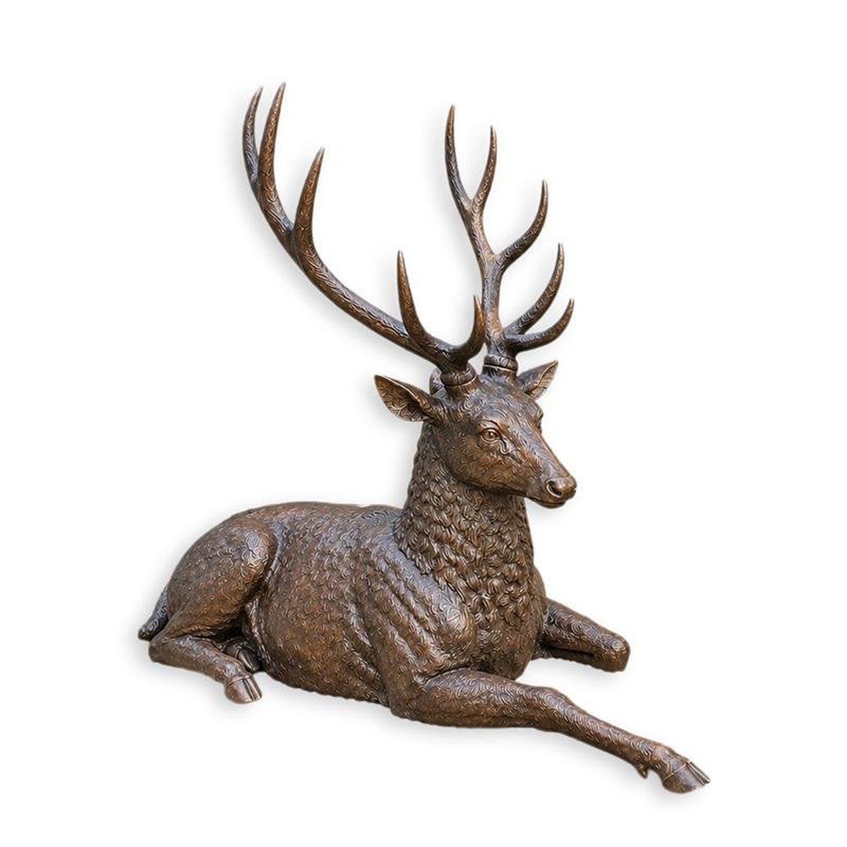 A BRONZE SCULPTURE OF A RECLINING DEER
