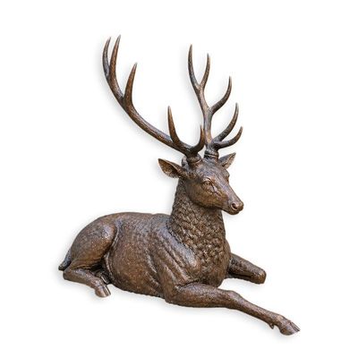 A BRONZE SCULPTURE OF A RECLINING DEER