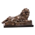 A BRONZE SCULPTURE OF A RECLINING LION