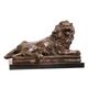 A BRONZE SCULPTURE OF A RECLINING LION