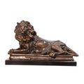 A BRONZE SCULPTURE OF A RECLINING LION