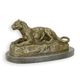 A BRONZE SCULPTURE OF A RECLINING LIONESS