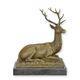 A BRONZE SCULPTURE OF A RECUMBENT DEER