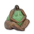 A BRONZE SCULPTURE OF A SITTING FEMALE